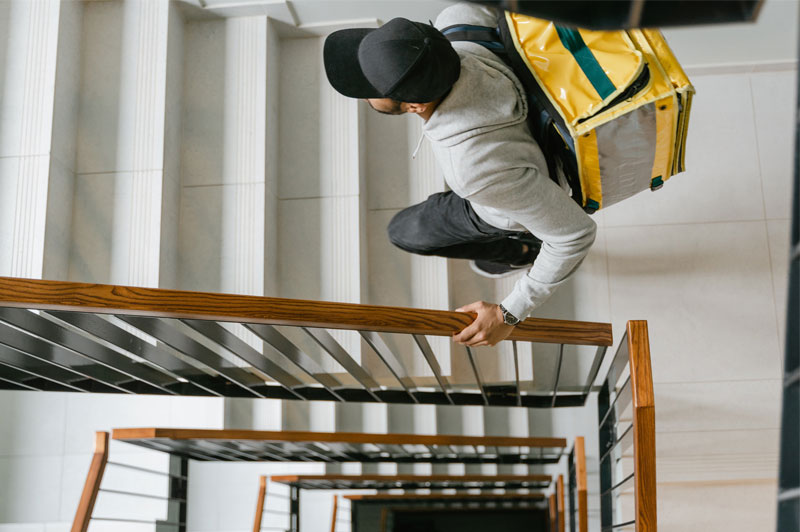 Delivery worker climbing stairs with slip-resistant shoes