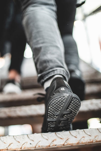 Waitress wearing black Endurance shoe featuring durable, supportive outsoles