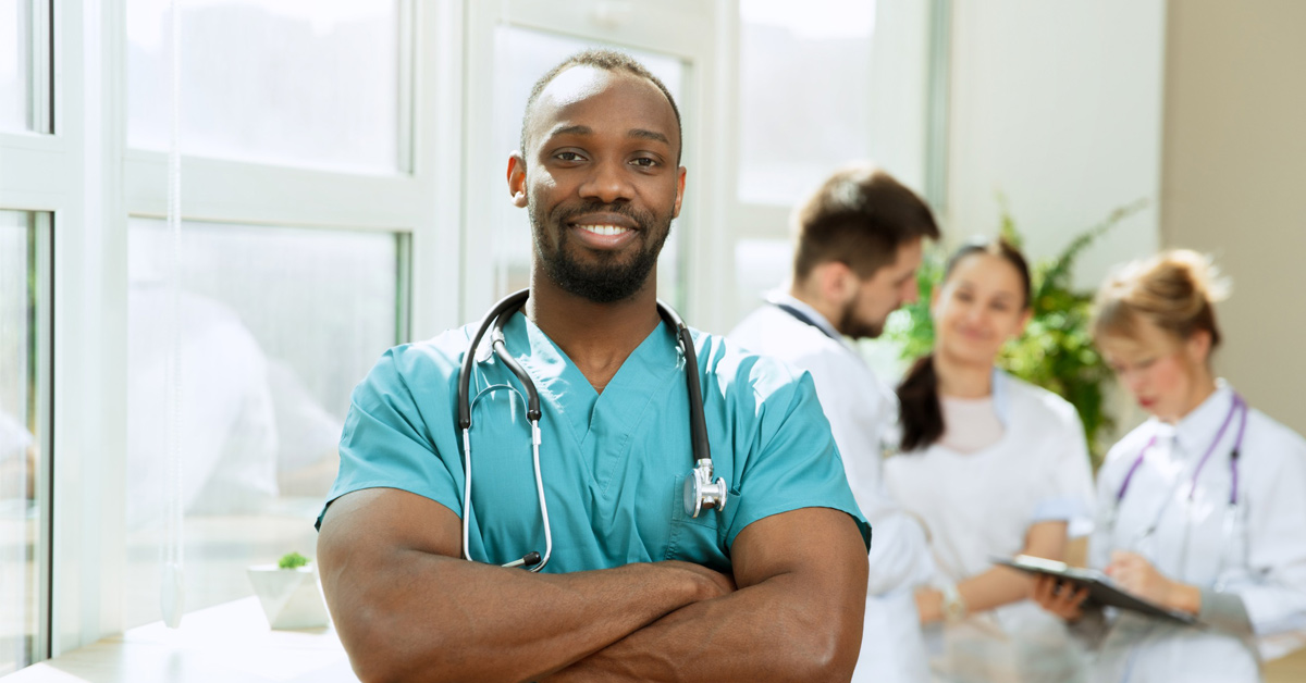 A group of healthcare workers standing in a hospital wearing different types of PPE